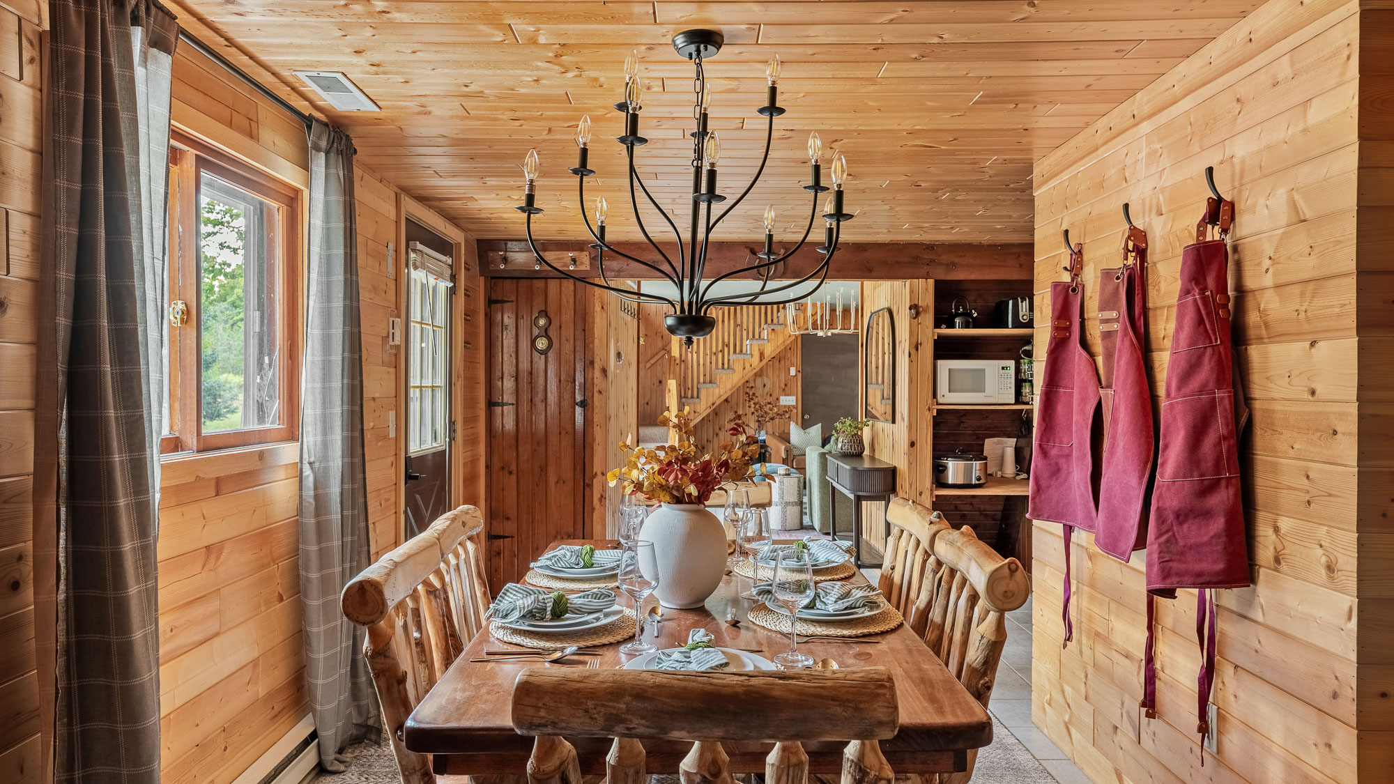 Warmly lit cabin dining room prepared for a real estate photo set